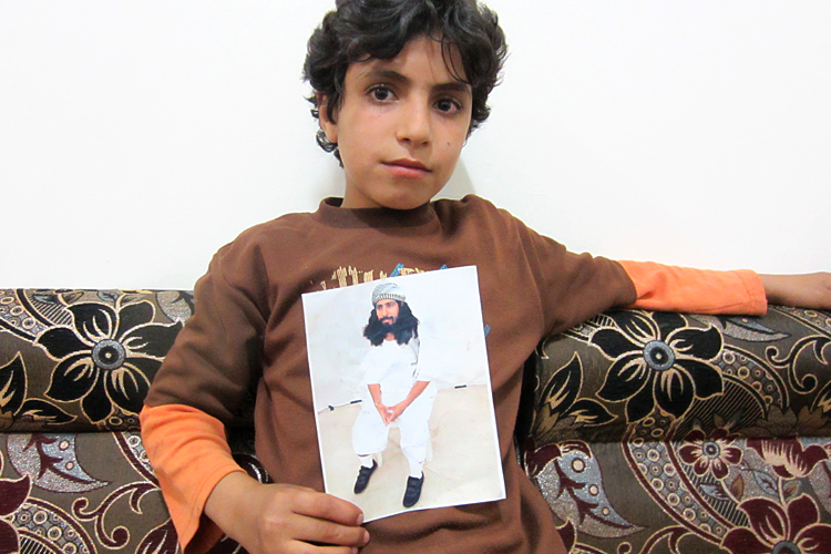 Muhammad al-Baidhani holds a photo of his father, Abdul Khaliq al-Bhaidani, who is held at Guantanamo without charge. (C) Letta Tayler, Human Rights