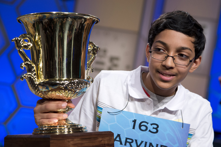 Arvind Mahankali, 13, of Bayside Hills, N.Y., holds the championship trophy after he won the National Spelling Bee by spelling the word "knaidel" correctly on Thursday, May 30, 2013, in Oxon Hill, Md. (AP Photo/Evan Vucci) (Evan Vucci)