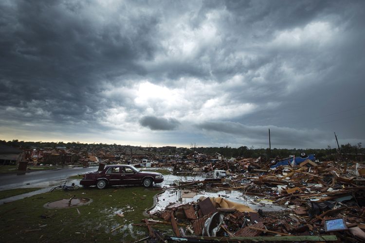 The clouds of a thunderstorm roll over neighborhoods heavily damaged in a tornado in Moore, Oklahoma, May 23, 2013. (Reuters/Lucas Jackson)