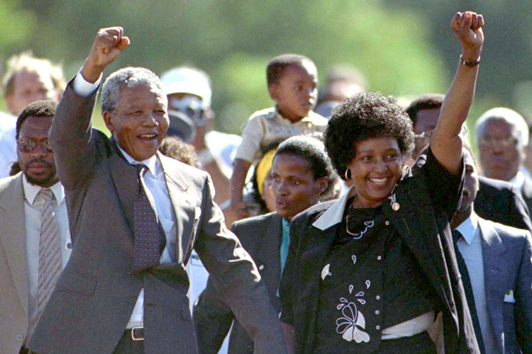 Nelson Mandela is accompanied by his former wife Winnie, moments after his release from prison February 11, 1990 after serving 27 years in jail. (© Reuters Photographer / Reuters)