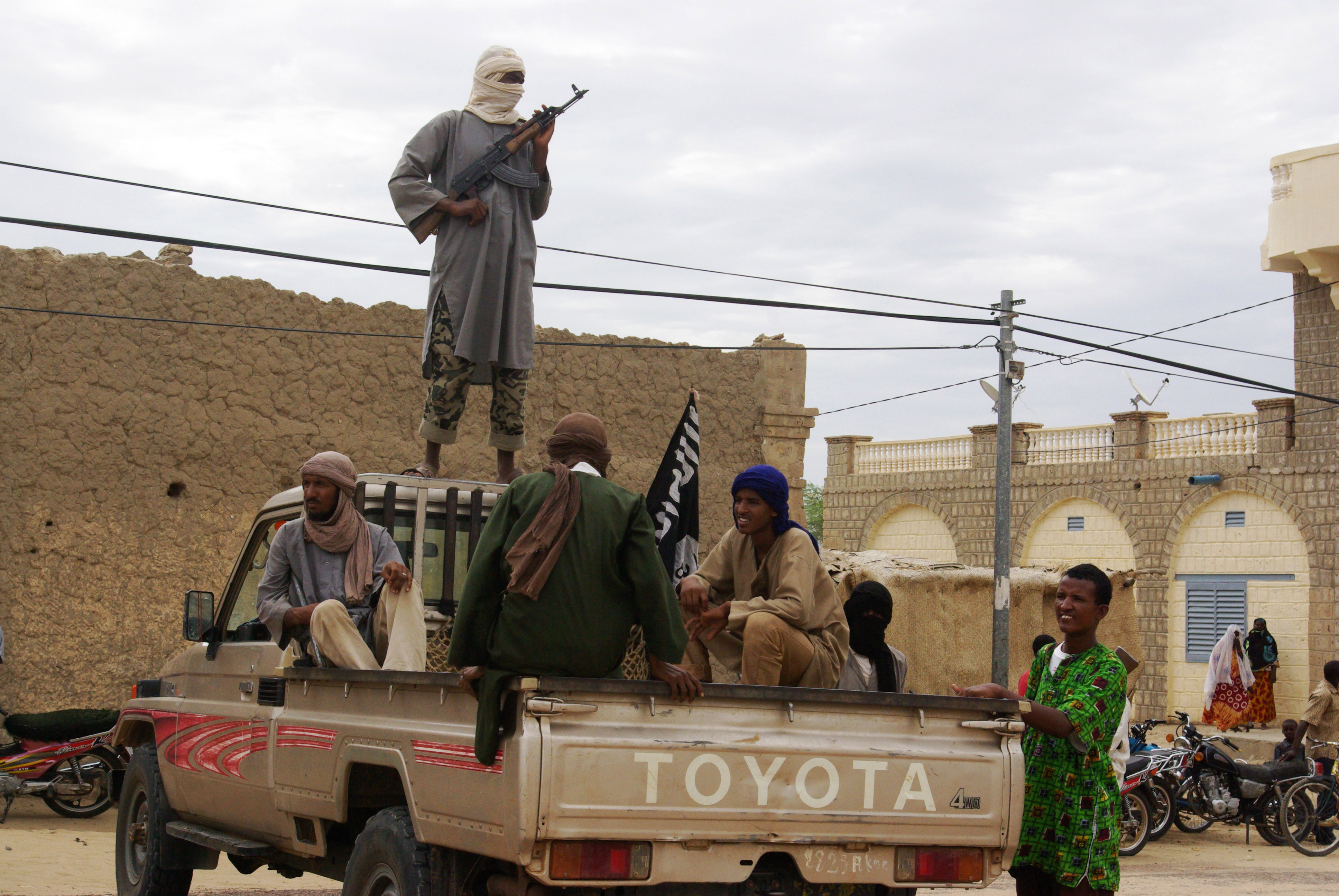 Fighters from Islamist group Ansar Dine stand guard in Timbuktu, Mali, as they prepare to publicly lash a member of the Islamic Police found guilty of adultery. (Associated Press)