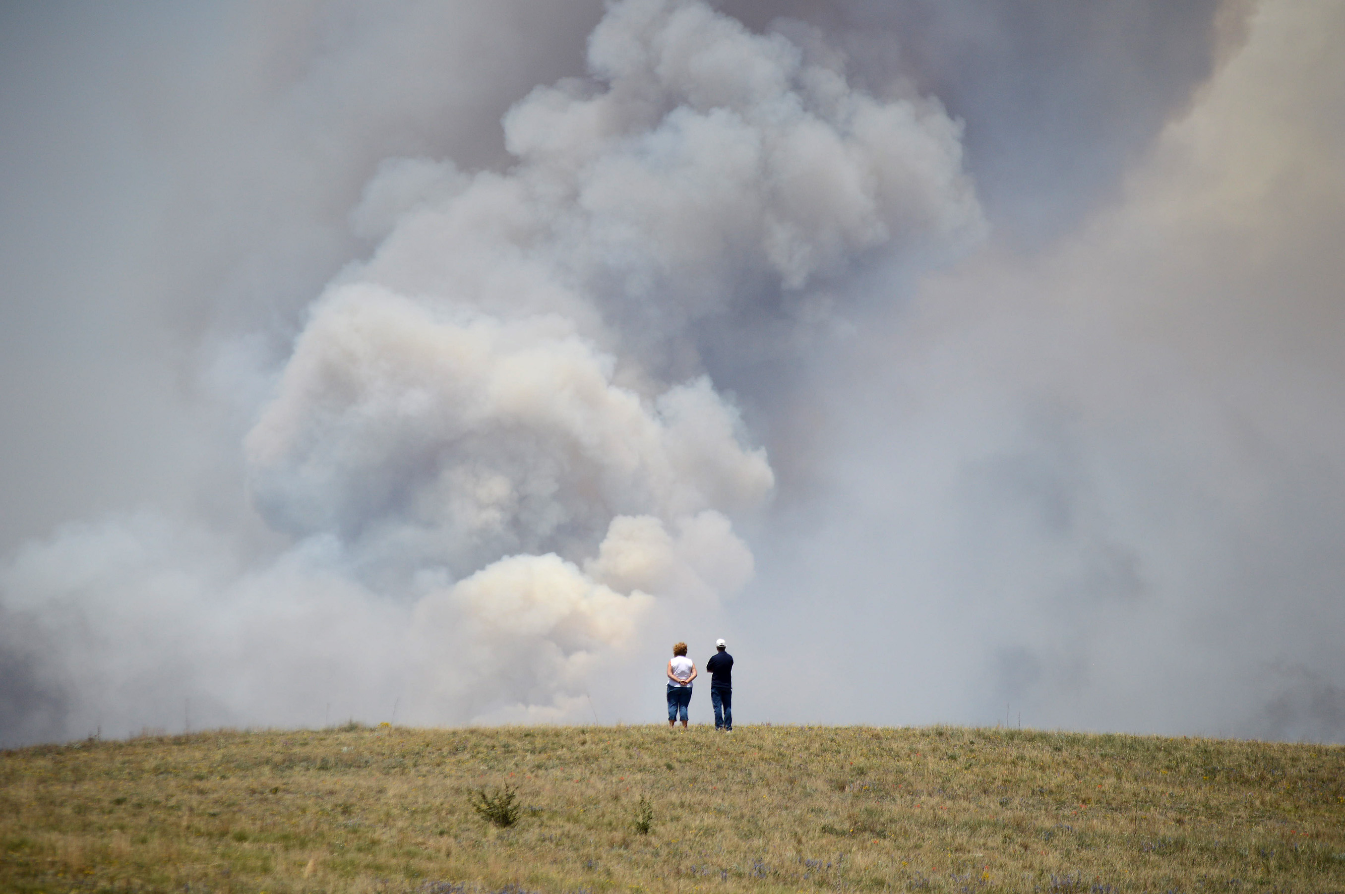 Chris and Christine Walker watch the Black Forest Fire gain steam as it burns out of control for a second straight day near Colorado Springs, Colo. on Wednesday, June 12, 2013. (AP/Bryan Oller)