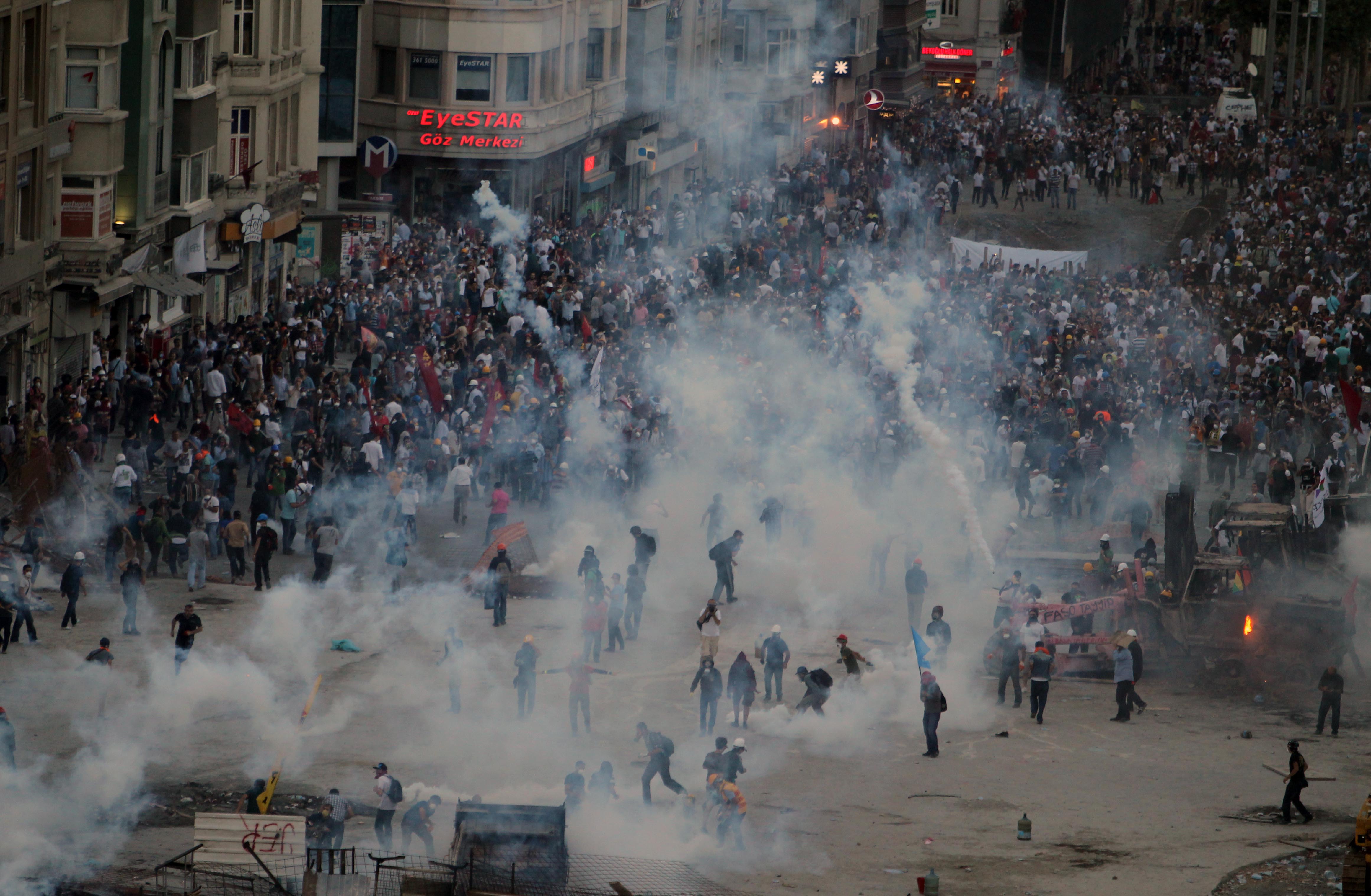 Police throw tear gas at protesters during clashes at the Taksim Square in Istanbul Tuesday, June 11, 2013. (AP/Thanassis Stavrakis)