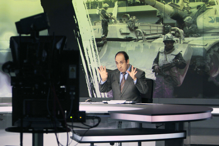 Announcer Abdul Samad Nasser, in the studio of the Arabic Al Jazeera satellite news channel. (Reuters/Fadi Al-assaad)