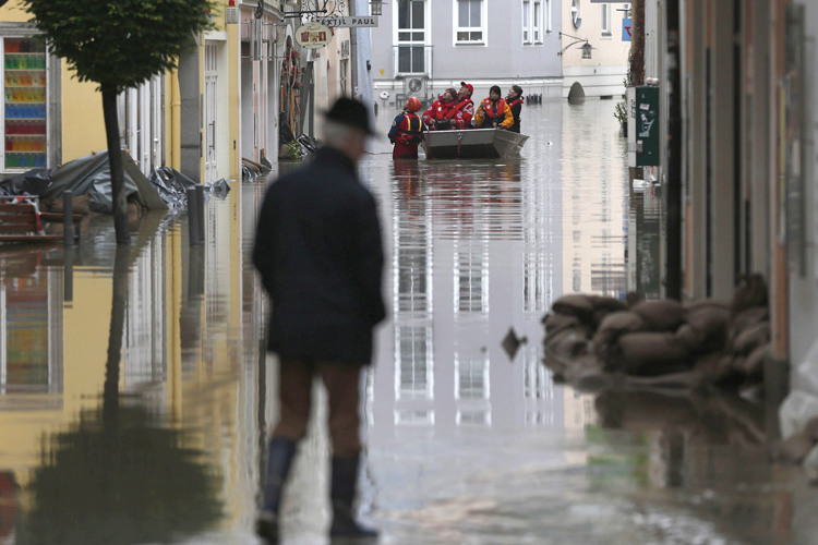 Red cross teams use boats to evacuate people  after river Danube flooded the old town of Passau, southern Germany, on Tuesday, June 4, 2013. Raging waters from three rivers have flooded large parts of the southeast German city following days of heavy rainfall in central Europe. (AP Photo/Matthias Schrader)