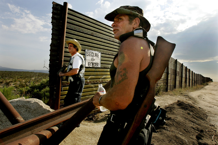 California Minutemen volunteers look over the Border wall for immigrants trying to cross into the United States in Campo, California. (AP/Sandy Huffaker)