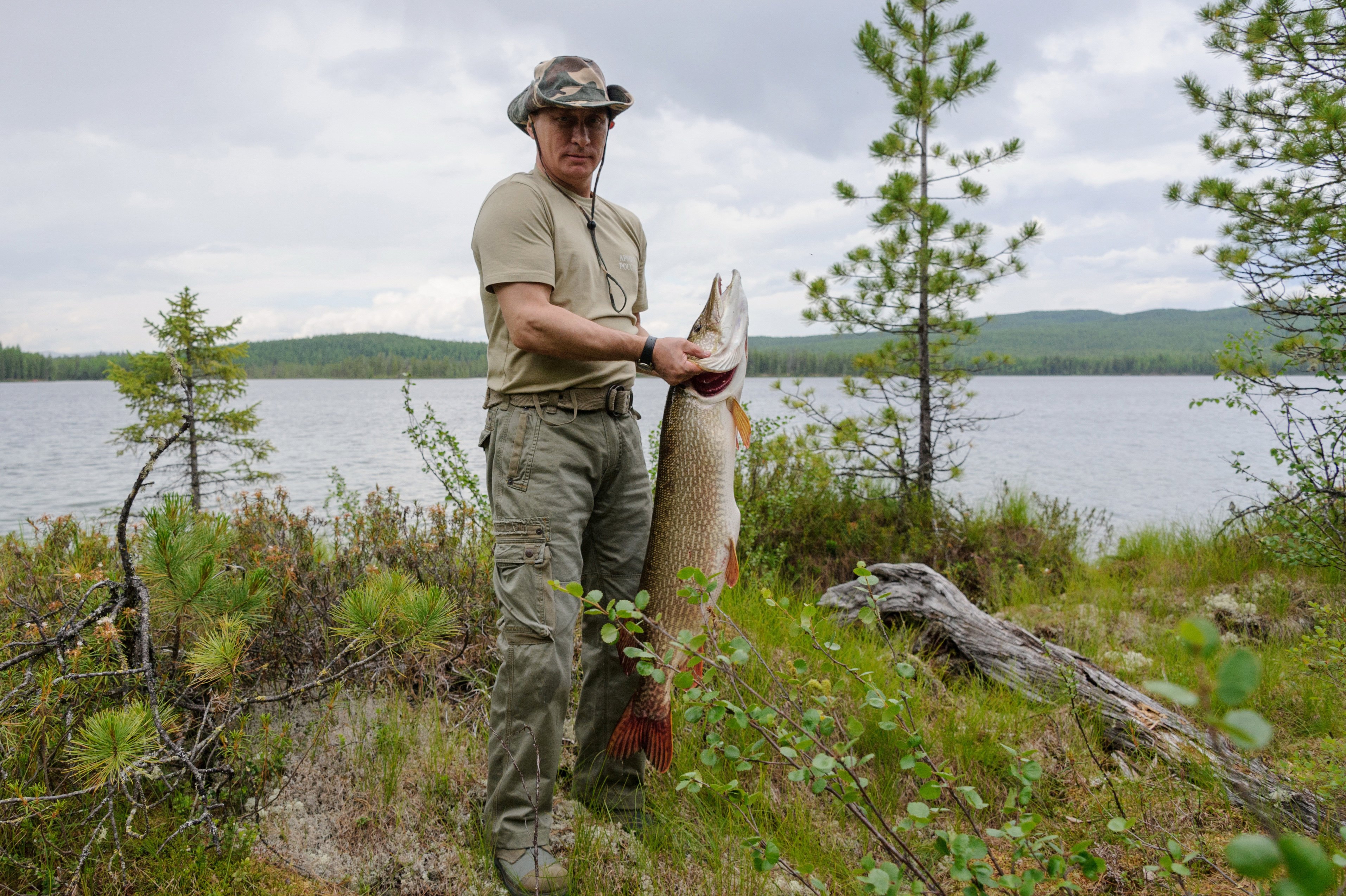 Russian President Vladimir Putin holds a big pike he caught while fishing during a mini-break in the Siberian Tyva region, Russia. (AP/RIA-Novosti, Alexei Nikolsky, Presidential Press Service)