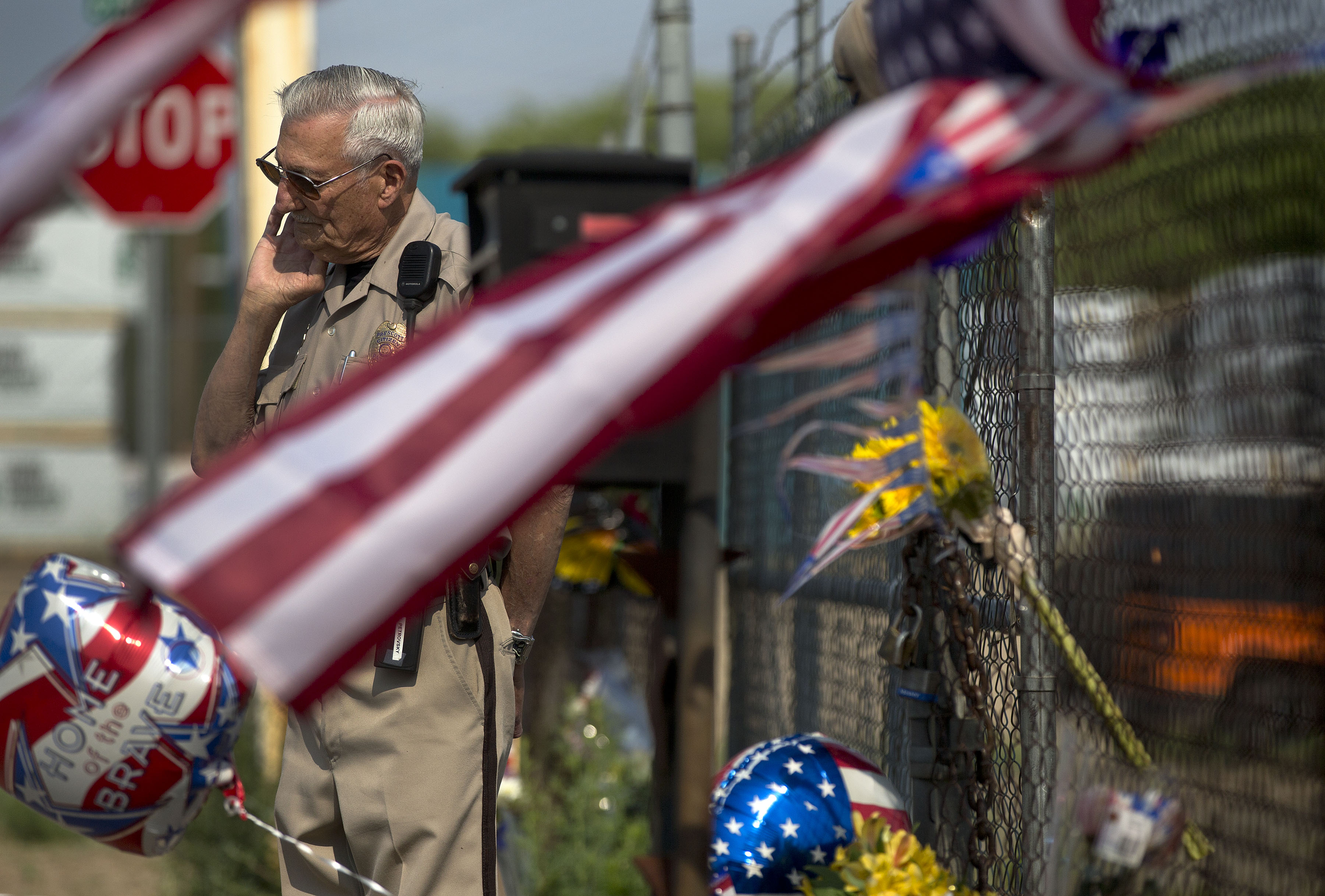 Volunteer citizen patrol officer Seymour Petrovsky stands guard at the gate to the Granite Mountain Interagency Hot Shot Crew fire station, Monday, July 1, 2013, in Prescott, Ariz. (AP/Julie Jacobson)