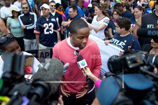 Former NFL football player Wade Davis speaks to reporters prior to the Chicago Gay Pride Parade, Sunday, June 30, 2013. (AP Photo/Scott Eisen)