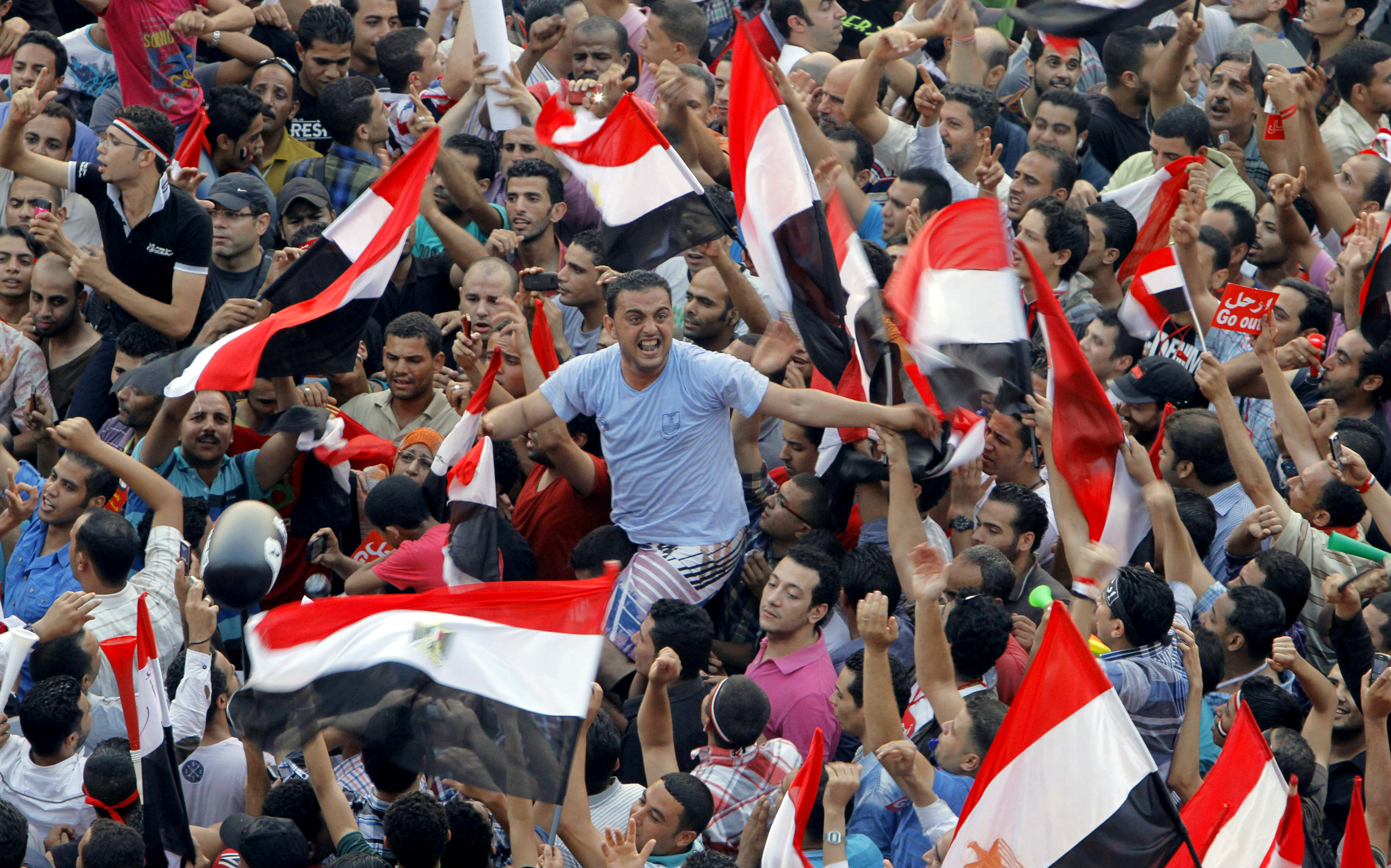 Opponents of Egypt's Islamist President Mohammed Morsi shout slogans and wave a national flags in Tahrir Square in Cairo, Egypt, Wednesday, July 3, 2013. (AP/Amr Nabil)