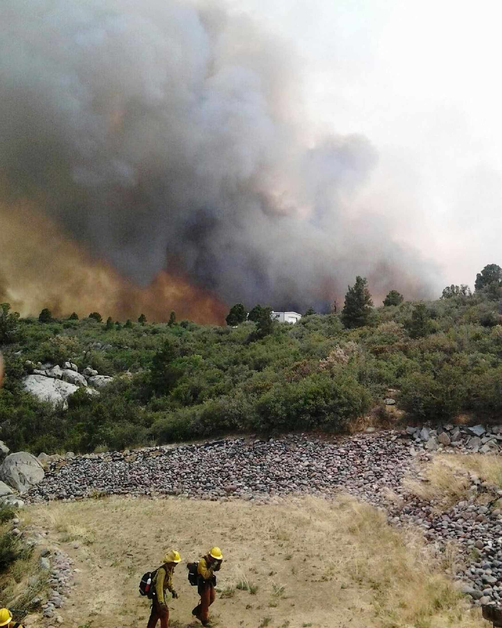 Firefighters move away from the Yarnell Hill Fire, near the town of Yarnell, Arizona, about 80 miles northwest of Phoenix. Nineteen firefighters were killed battling a fast-moving wildfire menacing a small town in central Arizona, the U.S. Wildland Fire Aviation service said on Sunday. (REUTERS/Arizona State Forestry Division/Handout)