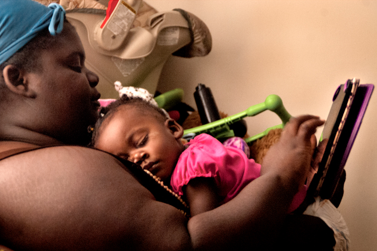 Jaqueta Cherry studying, while her daughter, Jah'Maya, sleeps (Adam Rust)