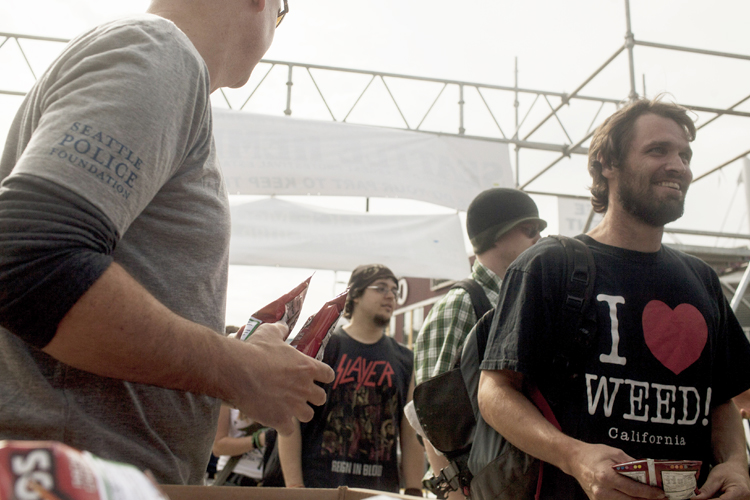 Seattle Police Department Detectives hand out bags of Doritos during the Hempfest rally in Seattle, August 17, 2013. (Reuters/Matt Mcknight)