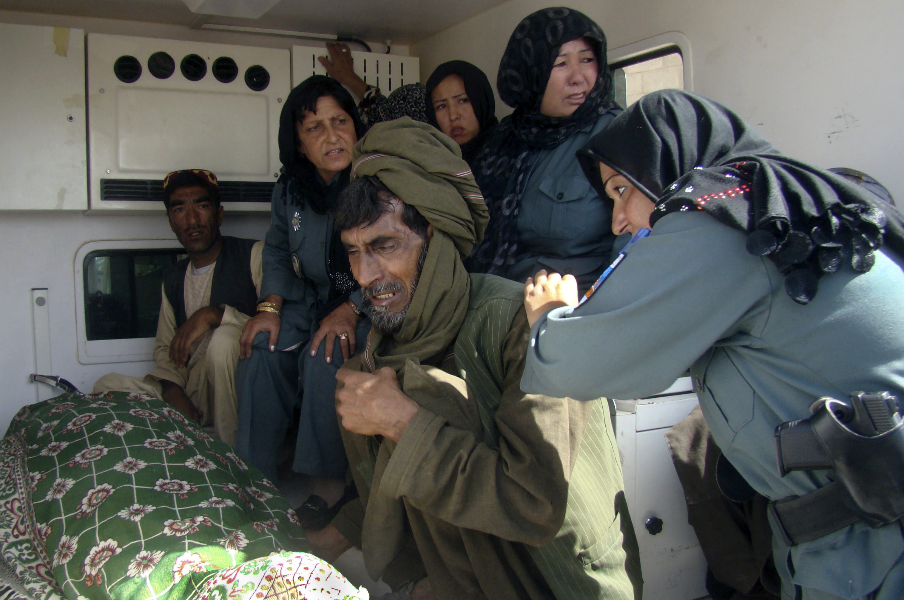 Afghan policewomen and relatives grieve over the body of the top policewoman in Helmand province, Negar. (AP Photo/Abdul Khaliq)