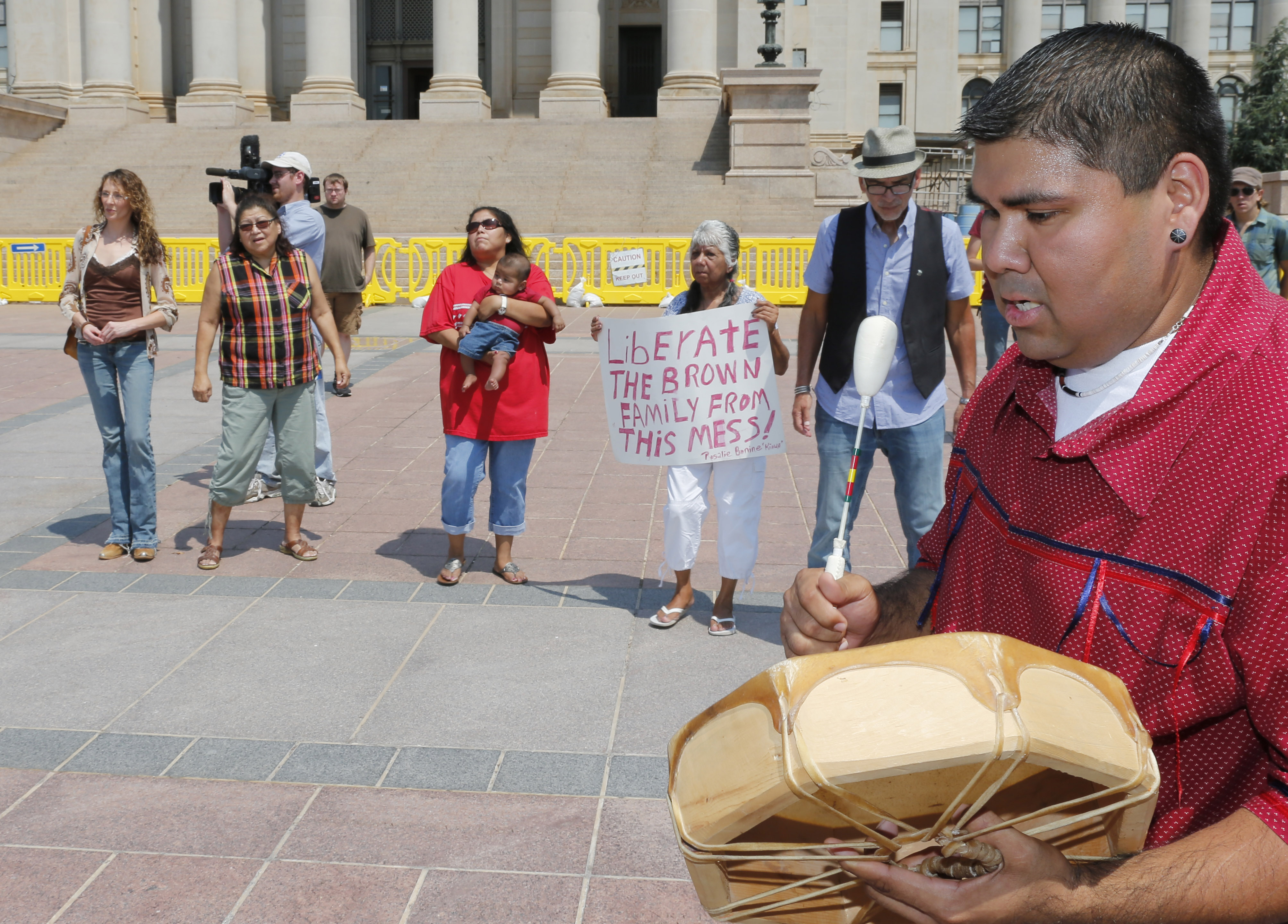 Chebon Kernell beats a drum and sings as participants dance during a rally in support of three-year-old baby Veronica. (AP/Sue Ogrocki)