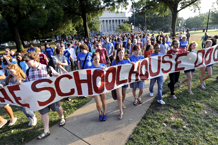 Students and faculty members of the Univ. of Alabama march across the campus to oppose racial segregation among its Greek-letter social organizations (AP/Dave Martin)