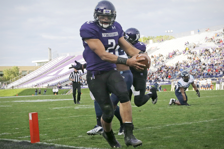 Northwestern quarterback Kain Colter wears the letters "APU" on his wristband during a game against Maine in Evanston, Ill., Sept. 21, 2013. (AP/Nam Y. Huh)