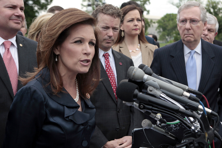 Mitch McConnell listens as Rep. Michele Bachmann speaks at a press conference with Tea Party leaders on Capitol Hill in Washington May 16, 2013. (Reuters/Yuri Gripas)