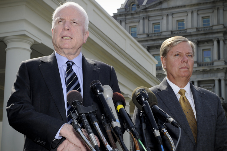 John McCain addresses the media as Lindsey Graham listens, on possible military action against Syria, in Washington September 2, 2013. (Reuters/Mike Theiler)