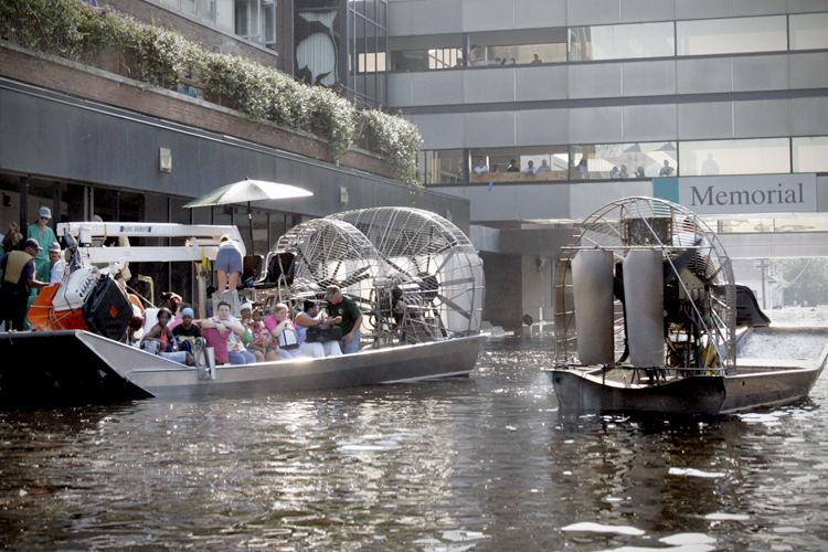 An airboat pulls up to the Memorial Medical Center in New Orleans on Wednesday, Aug. 31, 2005. (AP/Bill Haber)