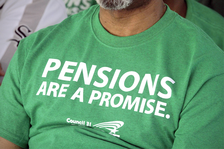 American Federation of State County and Municipal Employees union member wears their protest message on his shirt while rallying against the proposed pension legislation in Springfield, Ill. (AP/Seth Perlman)