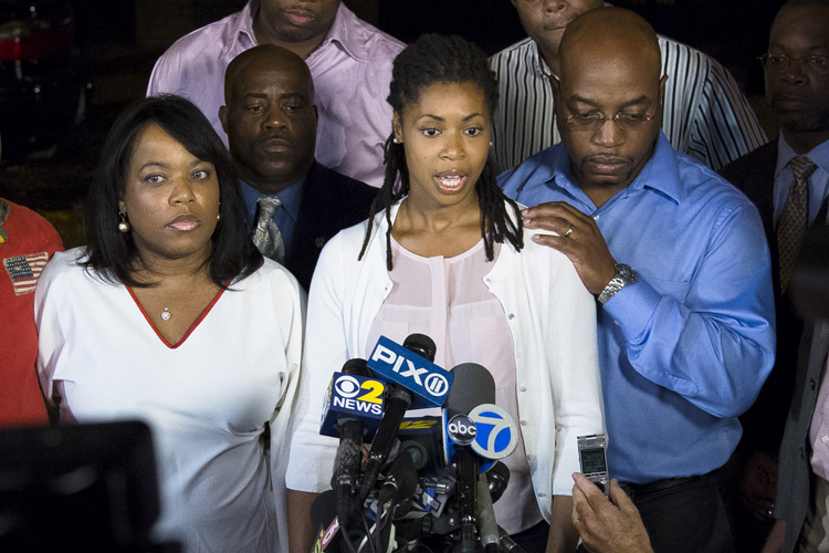 Amy Carey, center, sister of Miriam Carey, speaks to the media outside the home of her sister Valarie, second from left, in Brooklyn, Oct. 4, 2013. (AP/John Minchillo)