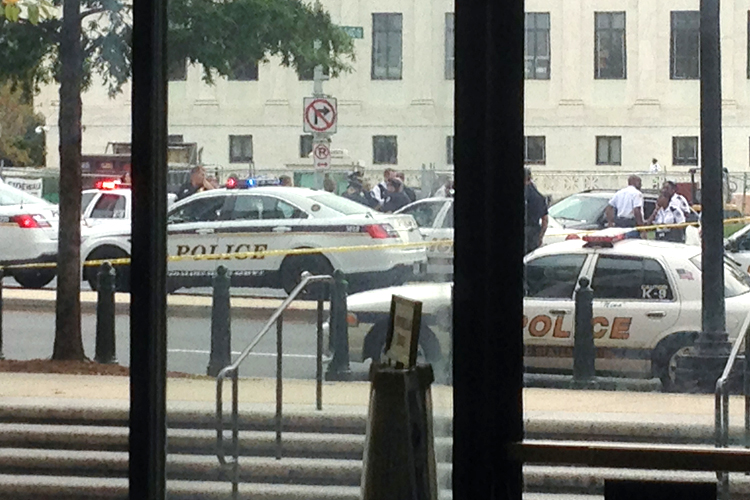 Law enforcement vehicles converge on the scene of a shooting on Constitution Avenue outside the Hart U.S. Senate Office Building as seen from inside the lobby of the building on Capitol Hill in Washington, October 3, 2013 (Reuters)