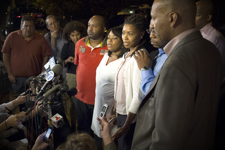 Amy Carey, fifth from right, sister of Miriam Carey, speaks outside the home of her sister Valarie in the Brooklyn, Oct. 4, 2013. (AP/John Minchillo)