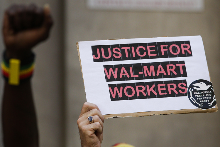 A protester holds up a sing during a protest against Walmart on Thursday, Sept. 5, 2013, in Los Angeles. (AP/Jae C. Hong)