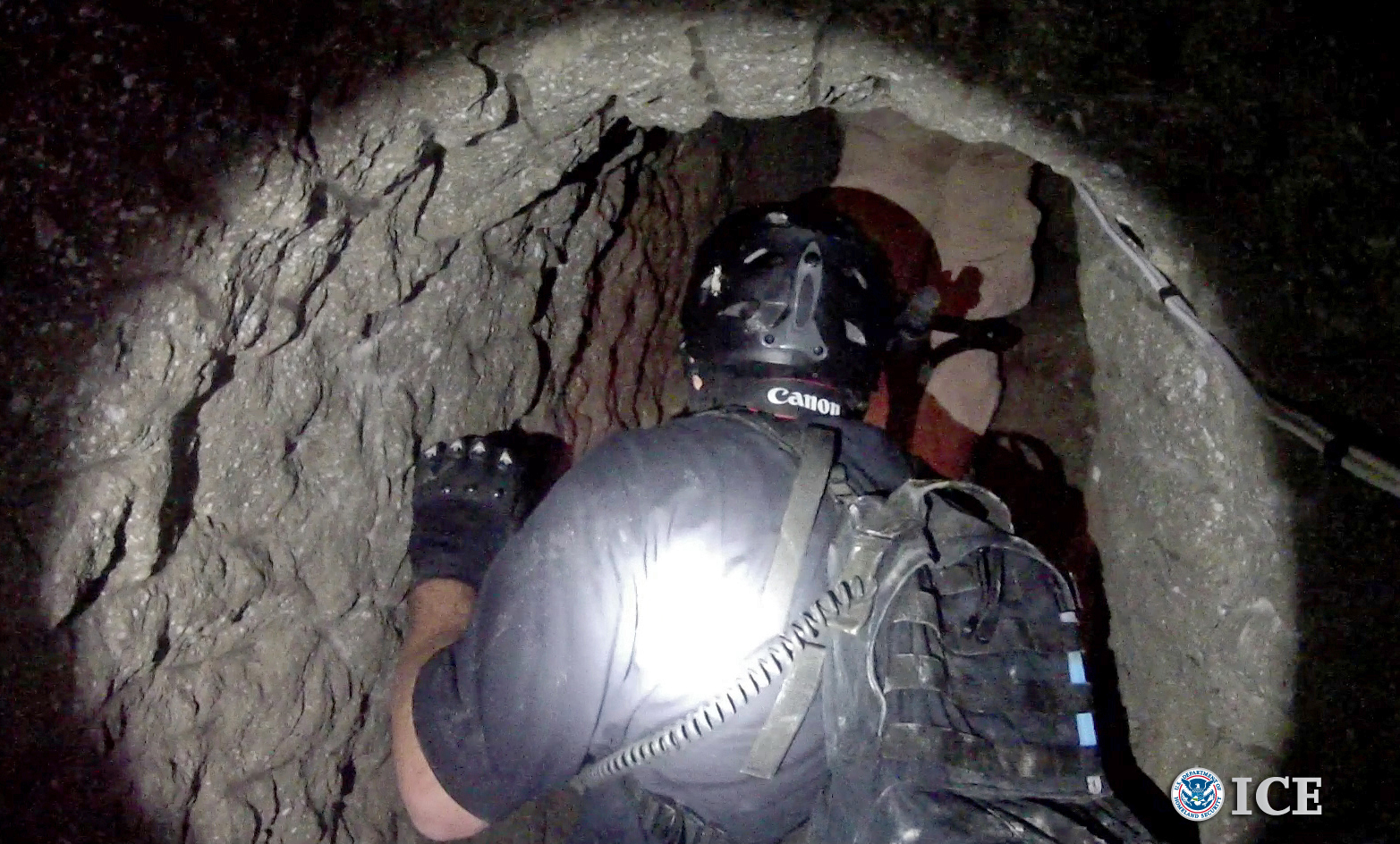 An Oct. 31, 2013, photo released by U.S. Immigration and Customs Enforcement shows agents in a tunnel designed to smuggle drugs from Tijuana, Mexico, to San Diego. (AP/U.S. Immigration and Customs Enforcement, Paul Caffrey)