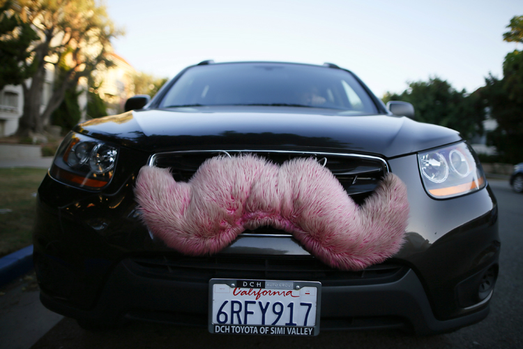A driver with the ride-sharing service Lyft waits for a customer on a street in Santa Monica, Calif., Oct. 17, 2013. (Reuters/Lucy Nicholson)