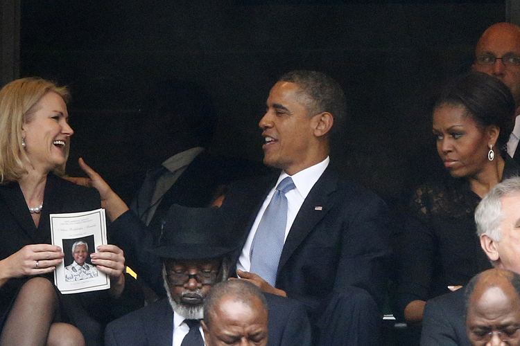 Barack Obama shares a moment with Denmark's Prime Minister Helle Thorning-Schmidt as Michelle Obama looks on during the memorial service for Nelson Mandela in Johannesburg, Dec. 10, 2013. (Reuters/Kai Pfaffenbach)