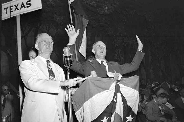 South Carolina Gov. Strom Thurmond reacts to applause from Dixiecrat's State's Rights Convention delegates in Birmingham, Ala., July 17, 1948. At left is Walter Sillers, convention chairman. (AP)
