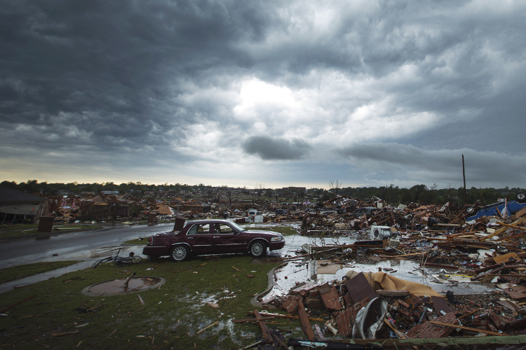 The clouds of a thunderstorm roll over neighborhoods heavily damaged in a tornado in Moore, Okla., May 23, 2013. (Reuters/Lucas Jackson)