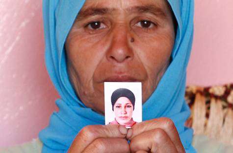 Zohra Filali holds a photo of her daughter, Amina (AP)
