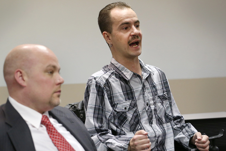 Brandon Coats, right, with his attorney, Michael Evans, left. (AP/Ed Andrieski)