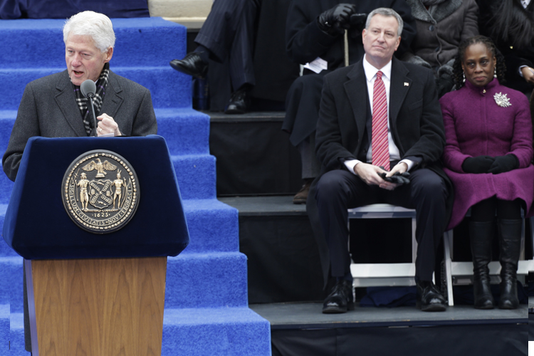 Bill Clinton speaks as Mayor-elect Bill de Blasio waits to take the oath of office, City Hall, Jan. 1, 2014, in New York. (AP/Frank Franklin Ii)