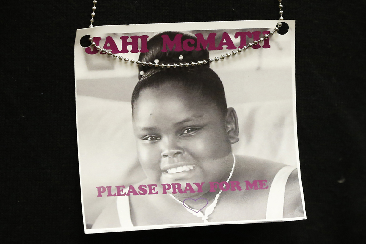 A photograph of 13-year-old Jahi McMath is seen on a necklace in Oakland, California December 24, 2013. (Reuters/Stephen Lam)