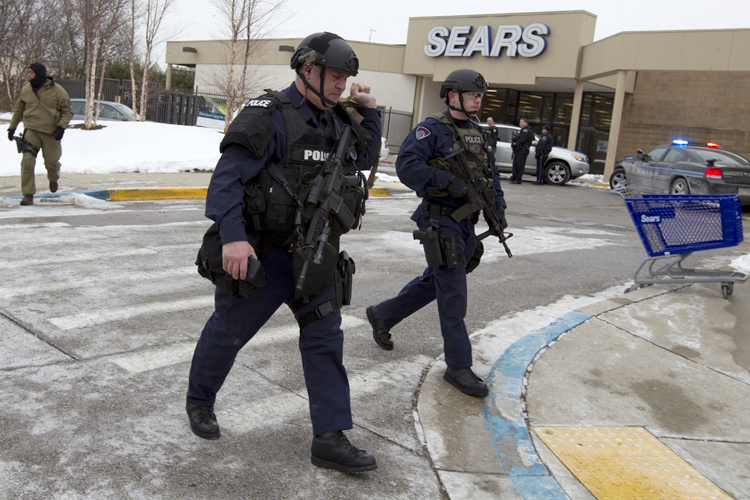 Police move in from a parking lot to the Mall in Columbia after reports of a multiple shooting, Saturday Jan. 25, 2014 Howard County, Md. (AP/Jose Luis Magana)