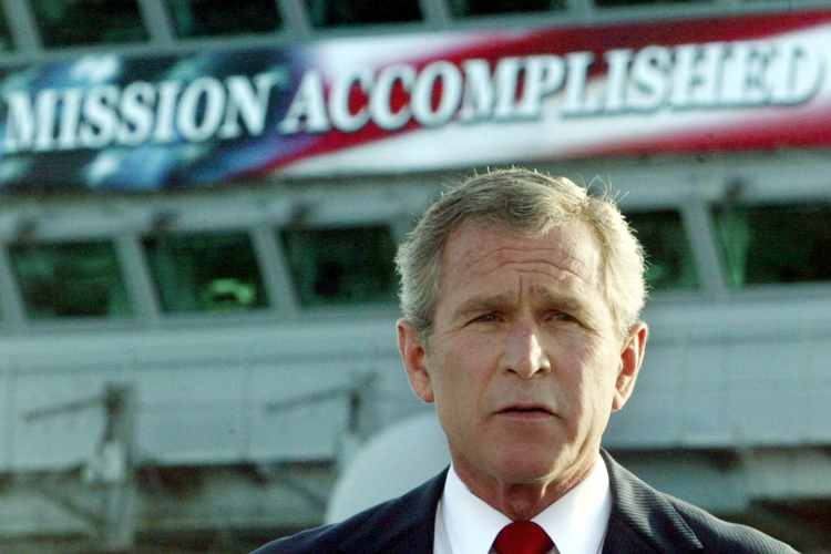 George W. Bush delivers a speech aboard the aircraft carrier USS Abraham Lincoln, May 1, 2003. (Reuters/Larry Downing)