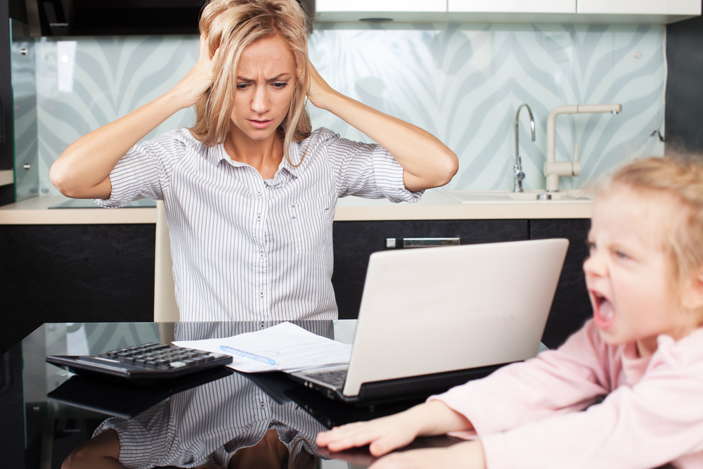 (<a href='http://www.shutterstock.com/pic-136611263/stock-photo-sad-woman-looks-at-the-bill-female-working-at-home-child-makes-moms-work.html'>  Gladskikh Tatiana </a> via <a href='http://www.shutterstock.com/'>Shutterstock</a>)