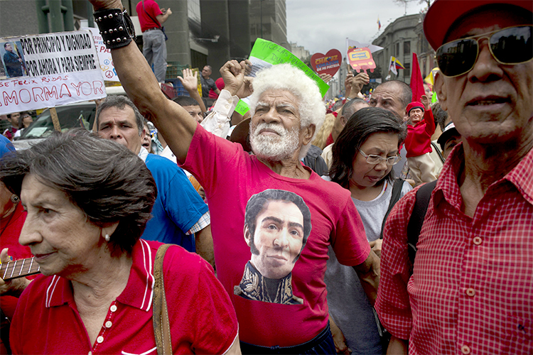 A man wearing a T-shirt of Venezuela's independence hero Simon Bolivar chants pro-government slogans during a march by elderly people in Caracas, Venezuela, Feb. 23, 2014. (AP/Rodrigo Abd)