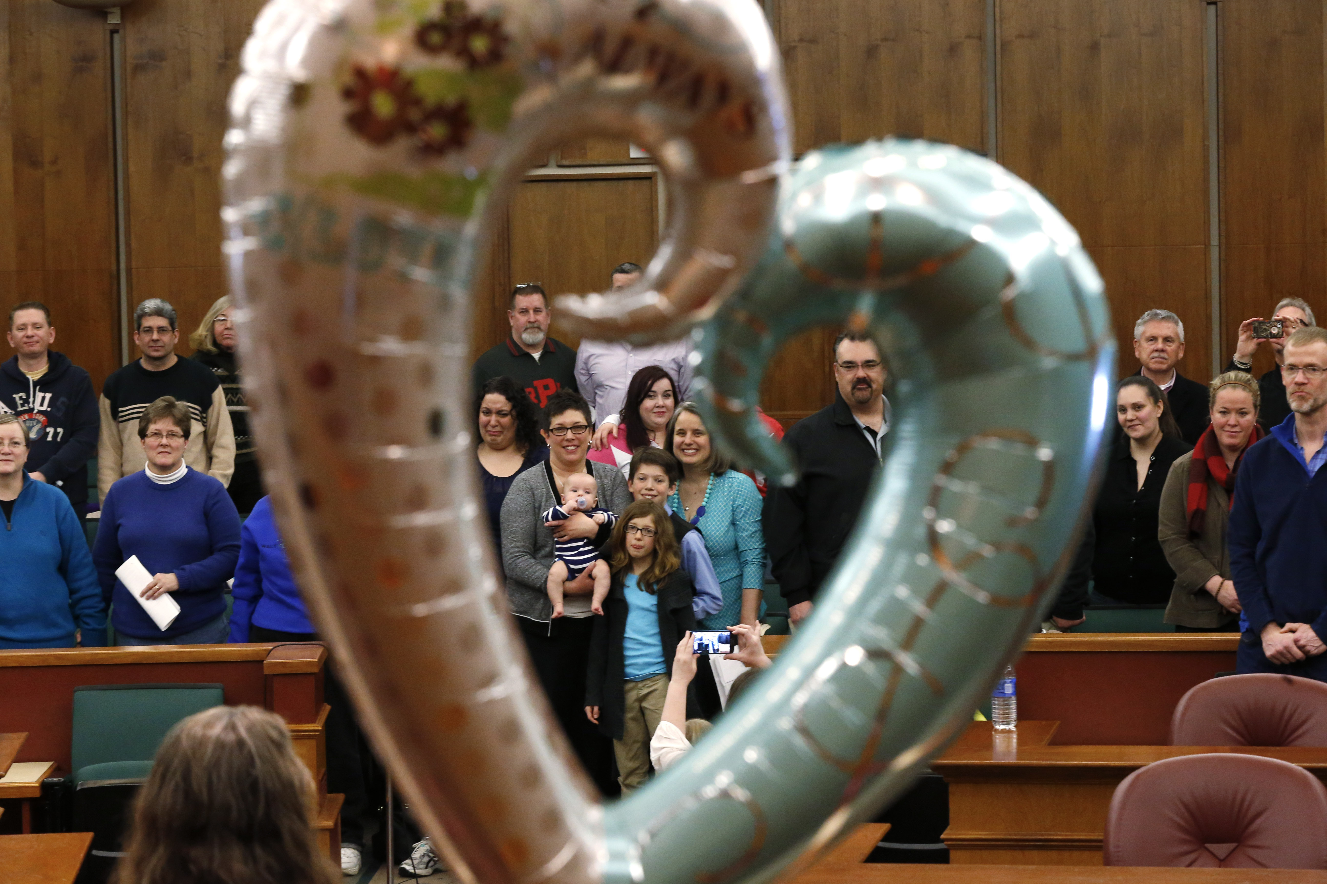 Same sex couples are married in a group by the Oakland County Clerk in Pontiac, Mich., Saturday, March 22, 2014. A federal judge has struck down Michigan's ban on gay marriage Friday the latest in a series of decisions overturning similar laws across the U.S. Some counties plan to issue marriage licenses to same-sex couples Saturday, less than 24 hours after a judge overturned Michigan's ban on gay marriage. (AP)