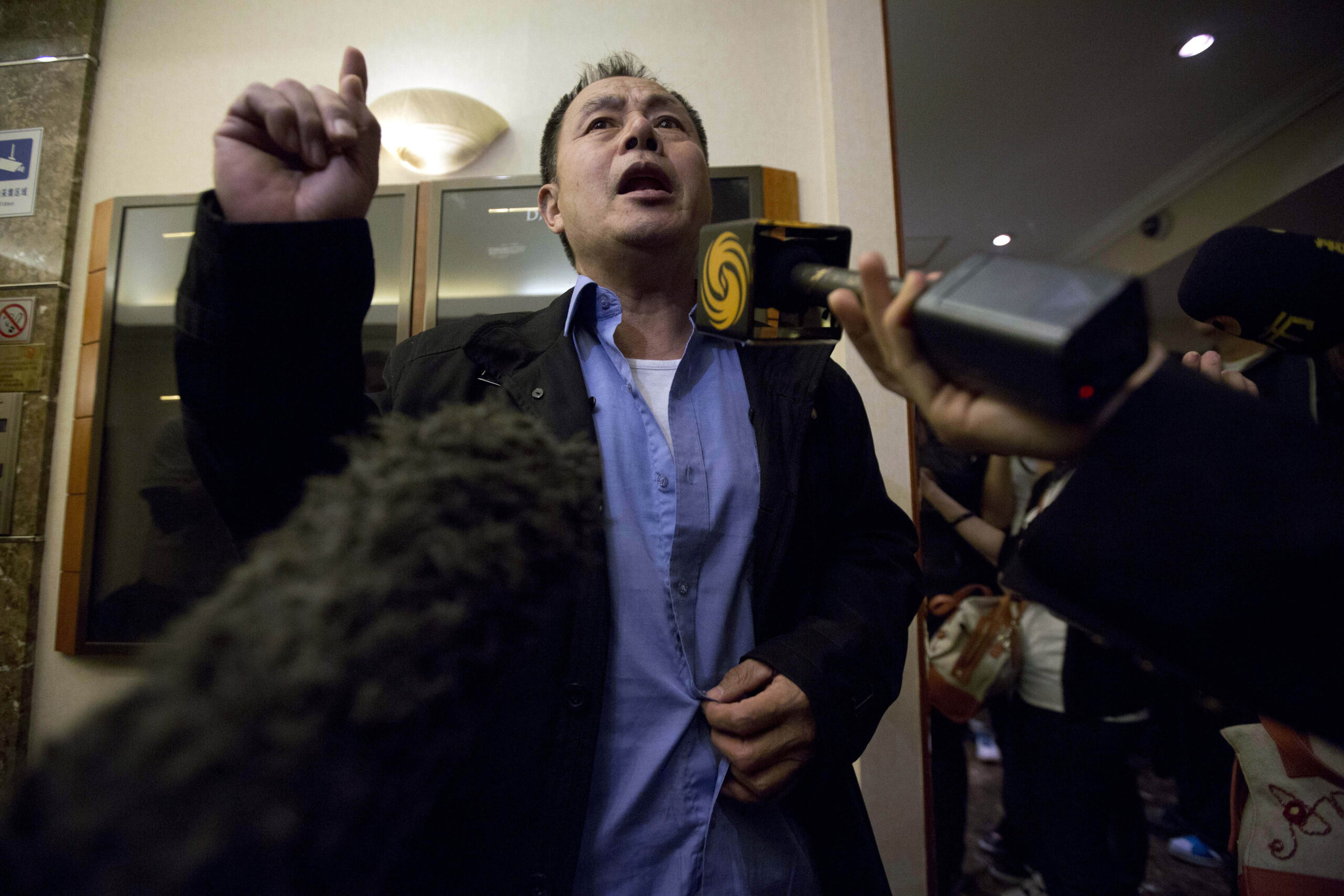 A relative of Chinese passengers aboard the missing Malaysia Airlines, MH370, speaks to journalists after attending a meeting with Malaysian government representatives in Beijing, China, Sunday, March 23, 2014. (AP Photo/Ng Han Guan) (Ng Han Guan)