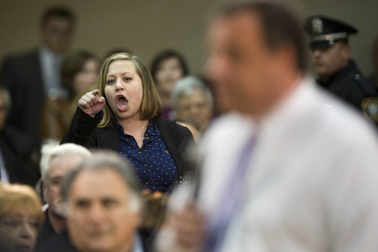 An audience member shouts at New Jersey Gov. Chris Christie at a town hall meeting, March 13, 2014. (AP/Matt Rourke)