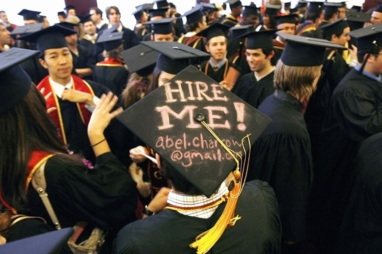 Graduating student Abel Charron displays a "Hire me" sign written on his mortar board before commencement at the University of Southern California, May 11, 2007. (Reuters/Mario Anzuoni)