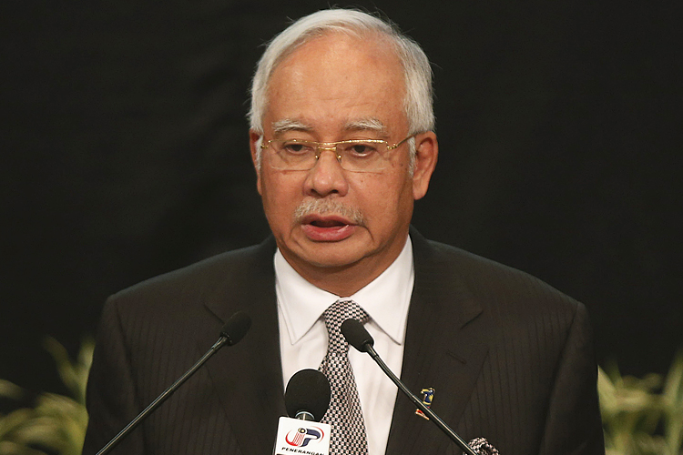 Malaysia's Prime Minister Najib Razak makes an announcement on the latest development on the missing Malaysia Airlines MH370 plane at Putra World Trade Center in Kuala Lumpur March 24, 2014. (Reuters/Edgar Su)