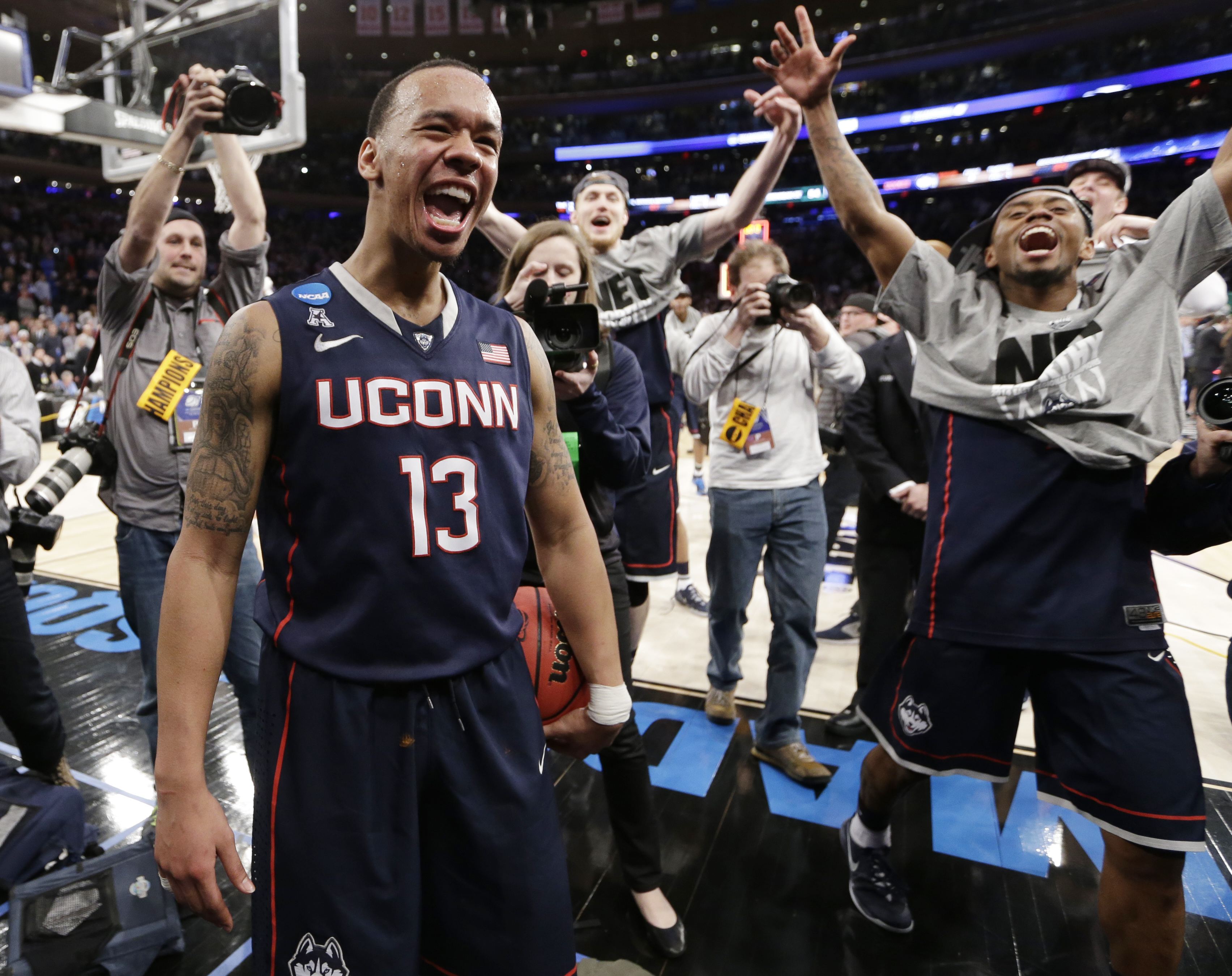 Connecticut's Shabazz Napier (13) celebrates after his team defeated Michigan State 60-54 in a regional final at the NCAA college basketball tournament, Sunday, March 30, 2014, in New York. Napier scored 17 points of his 25 points in the second half. (AP Photo/Frank Franklin II) (AP)