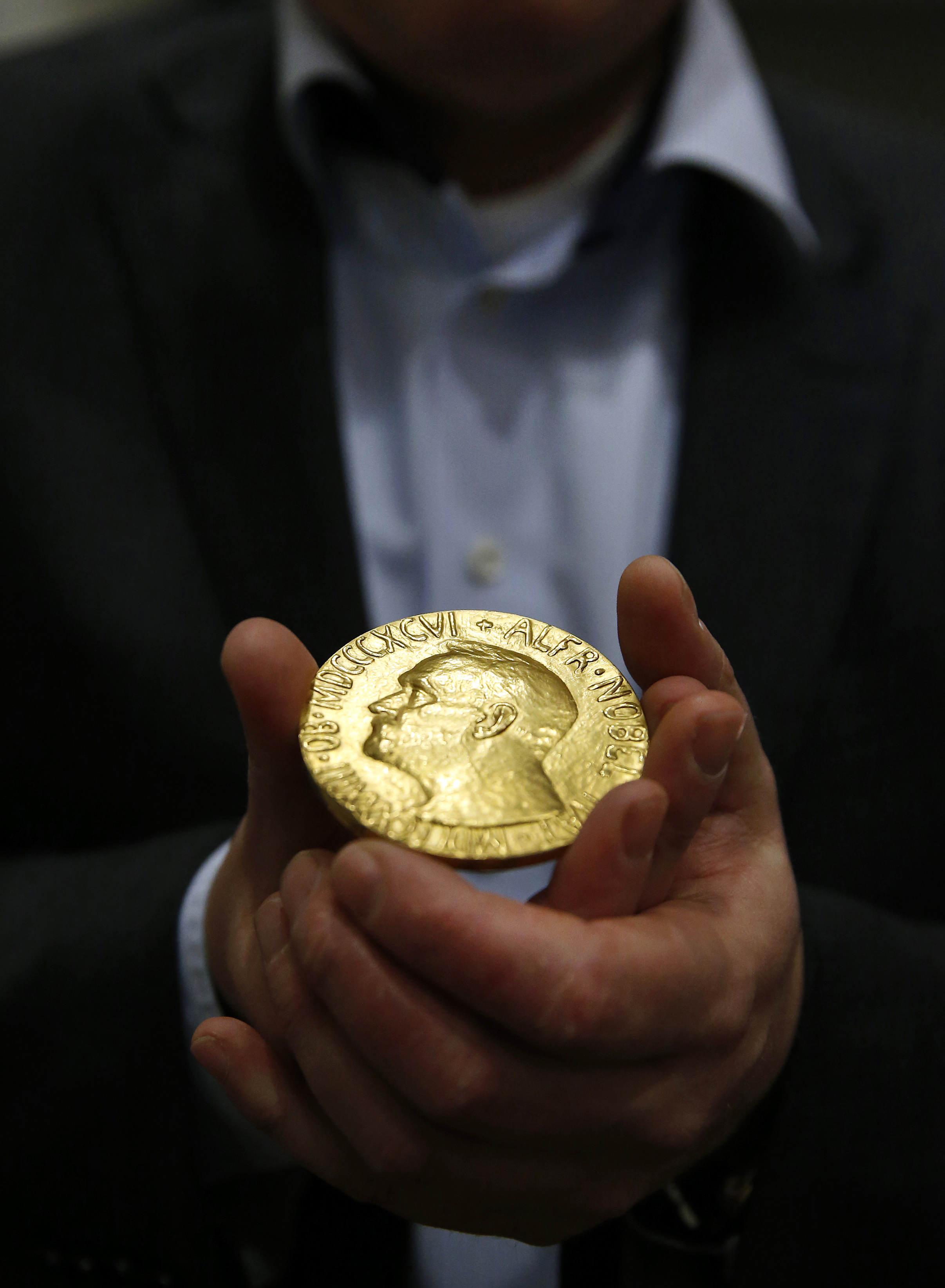 Bidder Ole Bjorn Fausa, of Norway, holds the 1936 Nobel Peace Prize medal in Baltimore, Thursday, March 27, 2014. (AP Photo/Patrick Semansky) (AP)