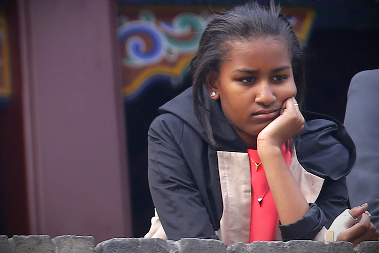 Sasha Obama watches a folk dance by performers during her visit at the City Wall, in Xi'an, Shaanxi province, March 24, 2014. (Reuters/Petar Kujundzic)